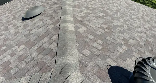 Weathered Wood roof with new turbine vent on a Houston home in 77065