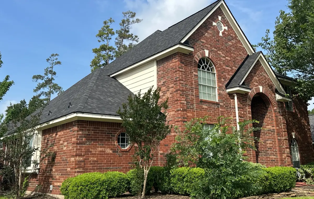 Front gable of the brick home with the completed roof, Cypress 77429