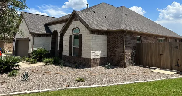 Driftwood laminate roof on a one-story stone-front Houston home in 77044