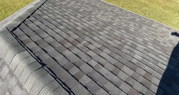Ridge cap and powered attic vent on a Pearland roof