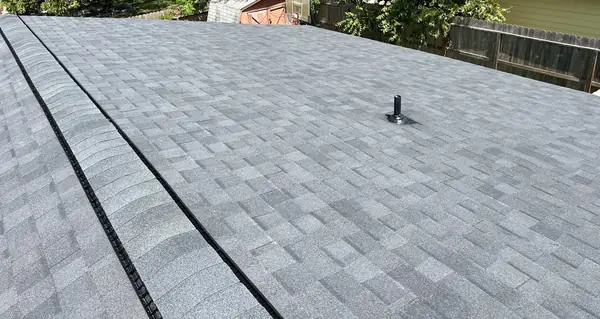 Ridge cap and slope of a new shingle roof in Houston, TX