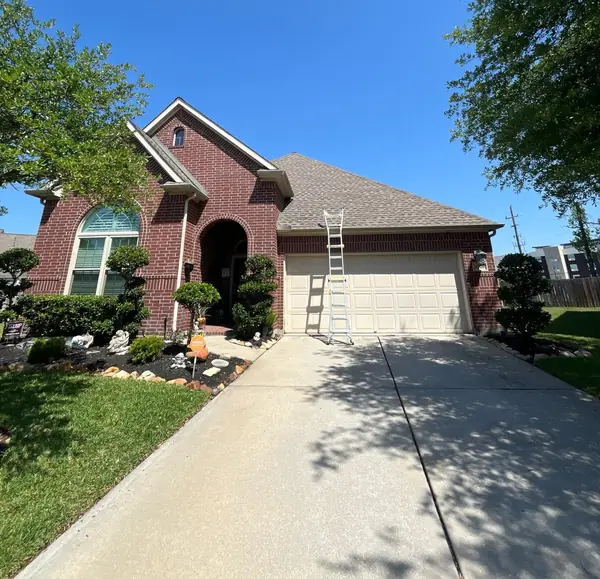 Front of the brick home with the replaced roof